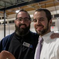 Two alumni posing for a photo together at the Fowling Fun Event